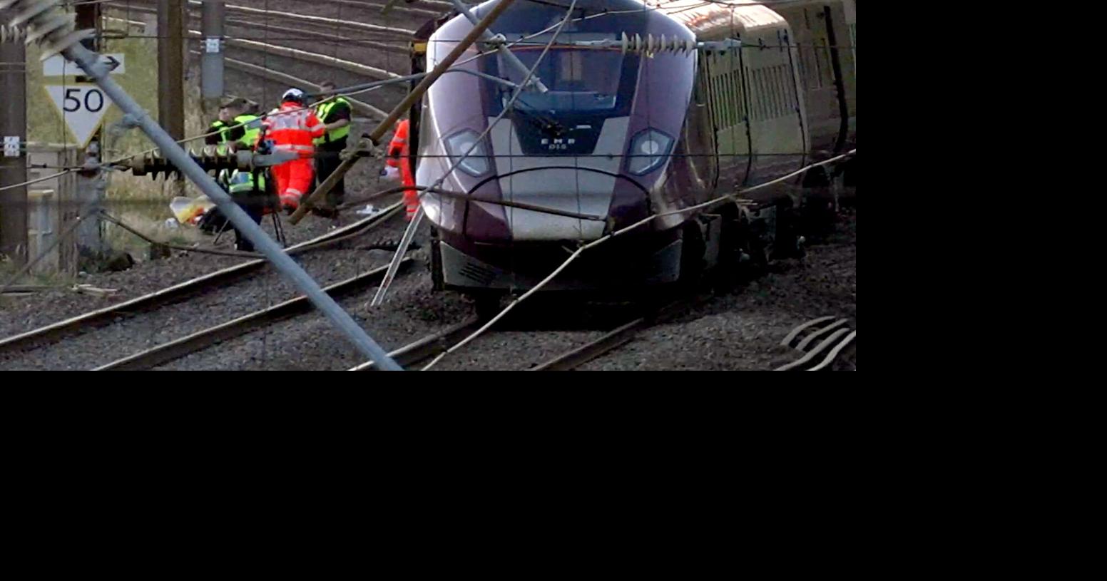 2 trains collide north of London, killing at least 1 person and injuring dozens