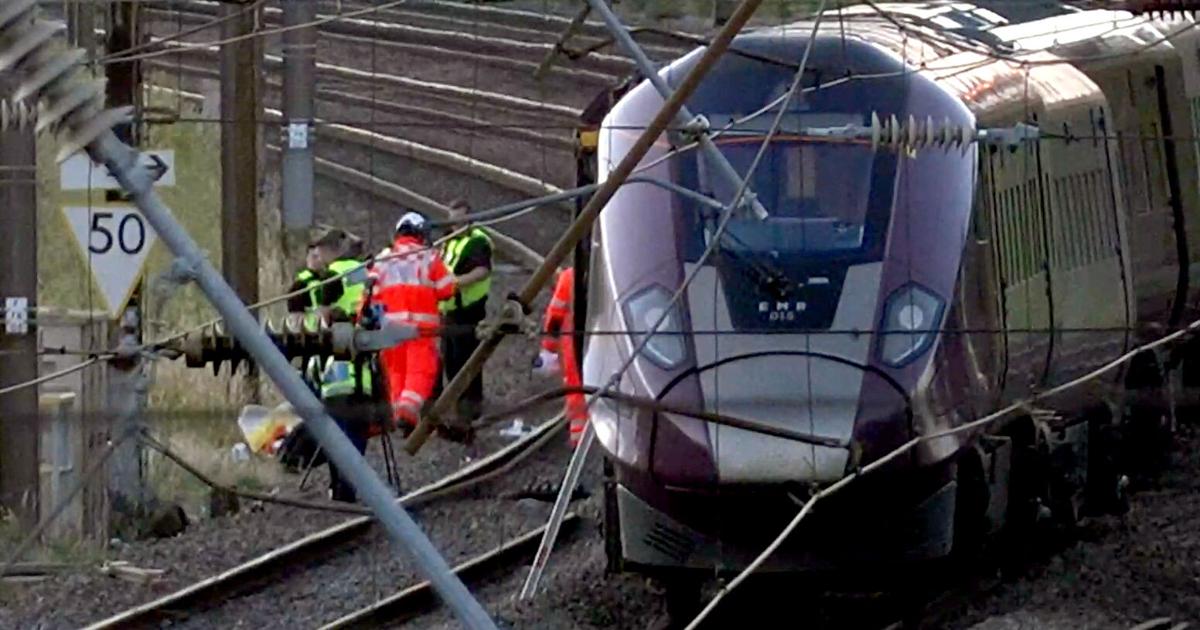 2 trains collide north of London, killing at least 1 person and injuring dozens