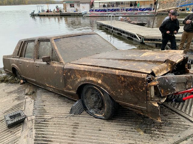 Authorities fish out long submerged car from river at Marquette