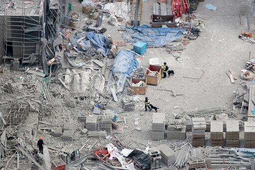 SKorean rescuers pull body from collapsed construction site