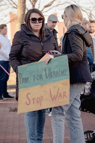 Woman holds pray for Ukraine sign