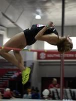Maggie Haase jumps over bar in high jump competition at track meet.