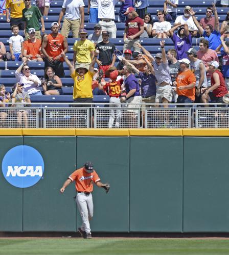 LSU's Greg Deichmann (7) is tagged out by Arkansas short stop Jax