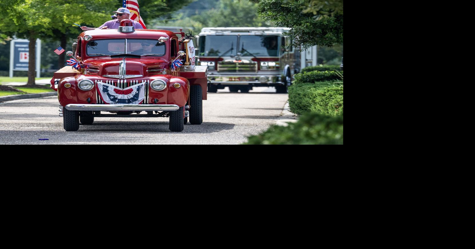 American flags, patriotic decorations adorn golf carts in Americana 4th of July parade in Zachary
