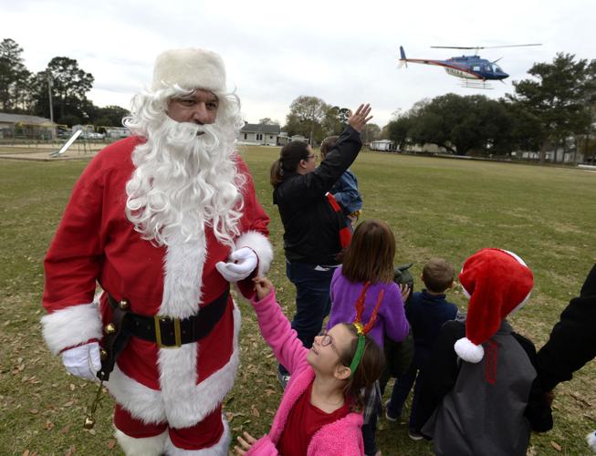 Ho ho ho! Santa trades sleigh for helicopter to spread Christmas cheer