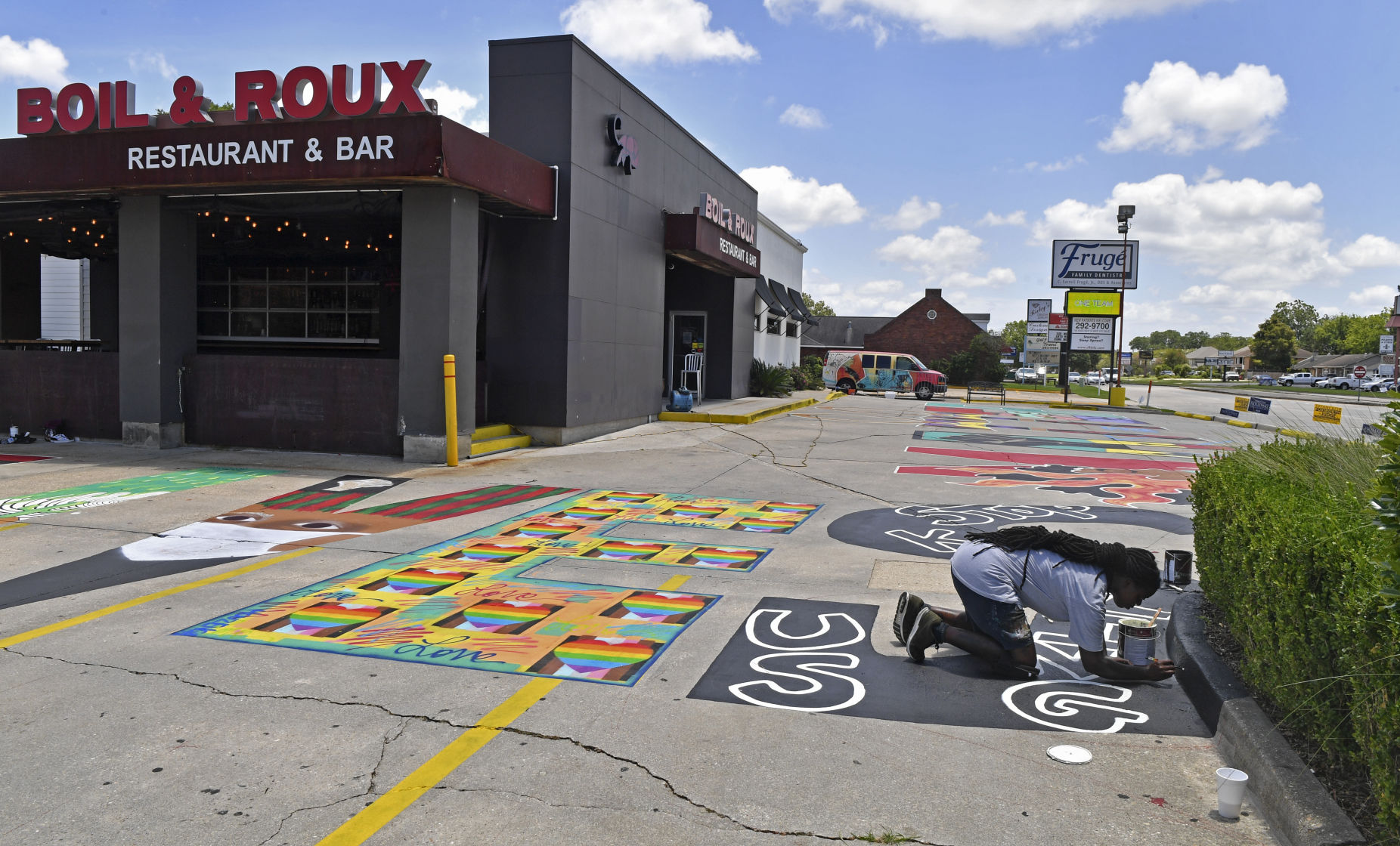 Photos A Black Lives Matter mural covers the parking lot of a Coursey