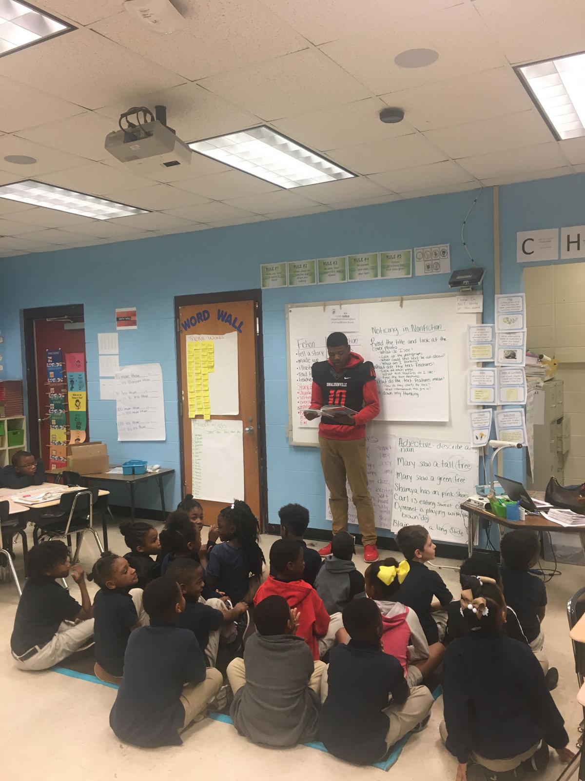 Donaldsonville football players read to elementary school children