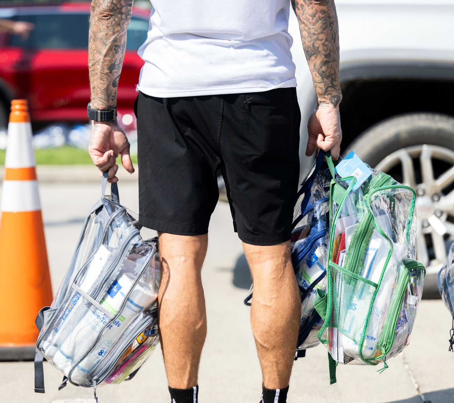 UFC Fighter Dustin Poirier, volunteers hand out backpacks 