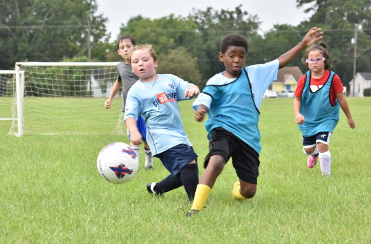 Kids enjoy a rainy first day of soccer camp Baker