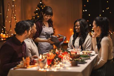 happy friends having christmas dinner at home