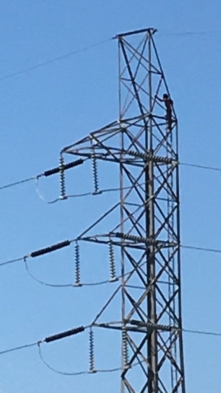 Naked man found atop power line tower in Pueblo
