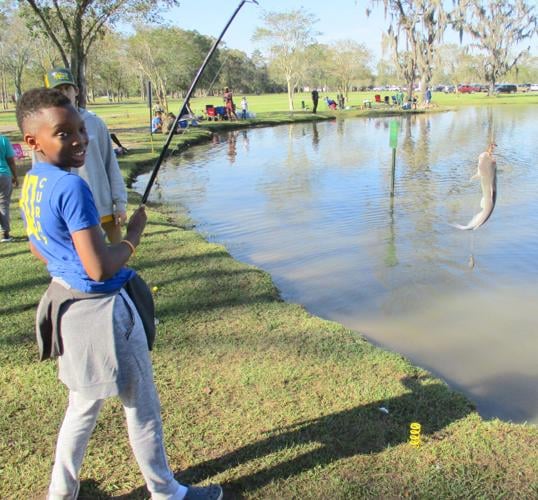 Anglers line pond at Sidney Hutchinson Park for annual fishing