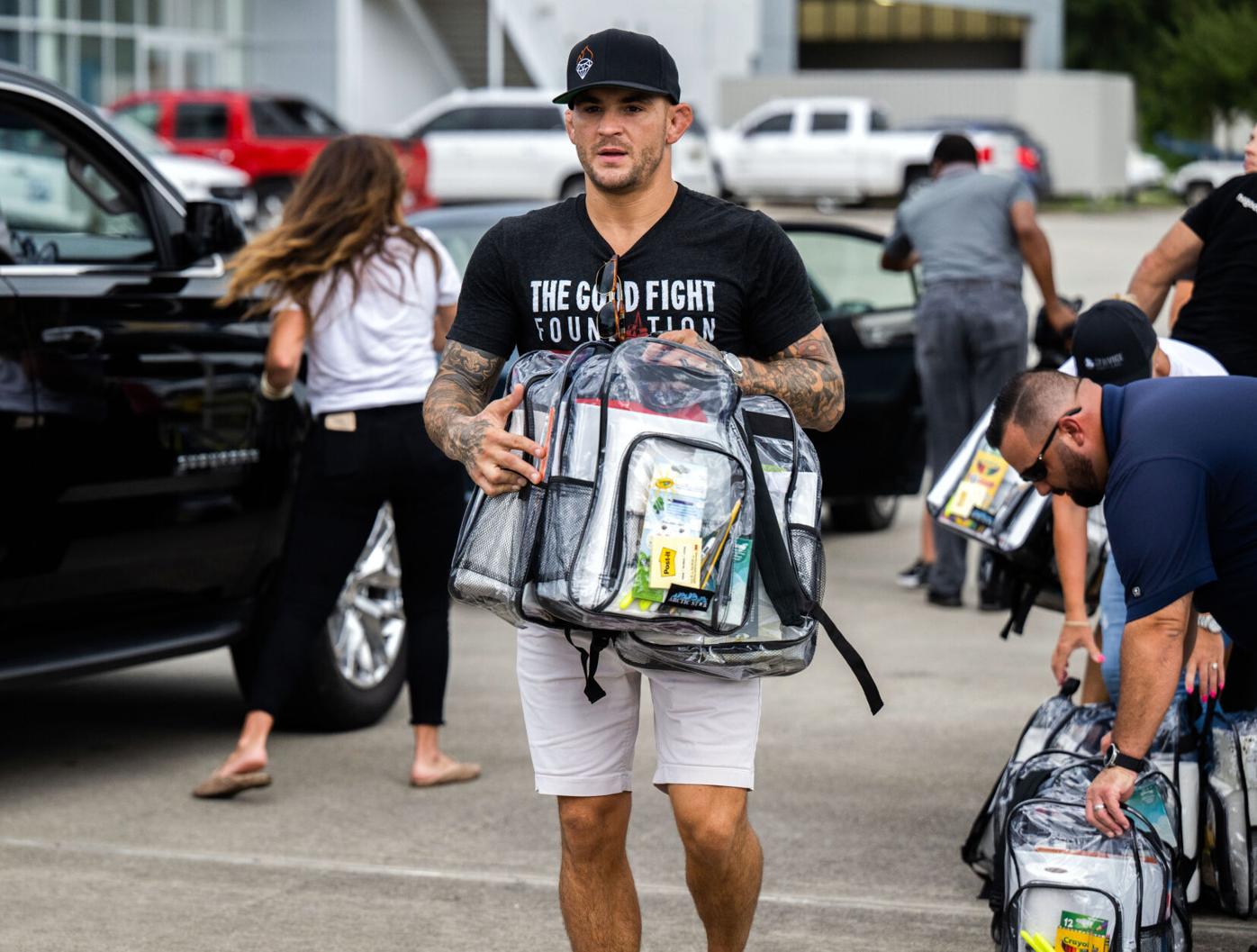 bags  Meet your Posher, Dustin UFC Fighter Dustin Poirier, volunteers hand out backpacks  main image 4