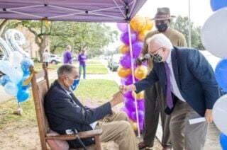 CMS Pastor Phil Brockett fist bumps Dr. William W. Sutton