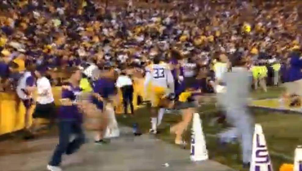 Tiger fans rush field after LSU victory _lowres