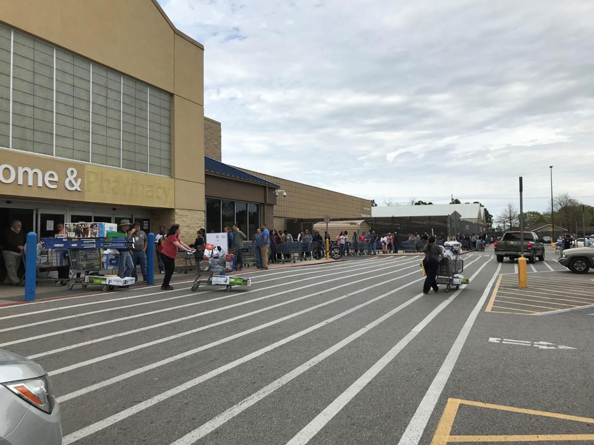 Shoppers line up around the building at Lafayette Walmart looking for