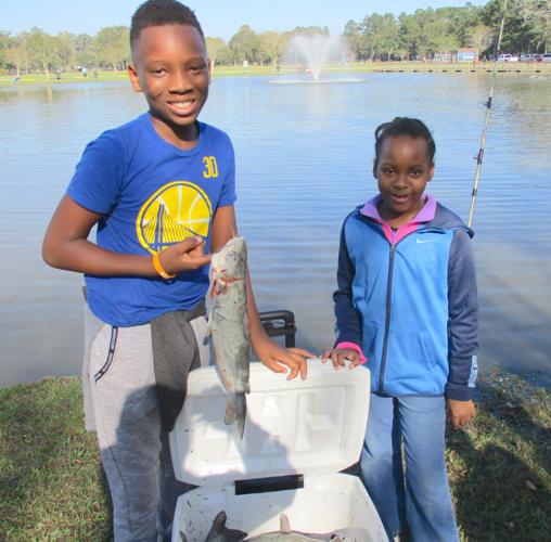 Anglers line pond at Sidney Hutchinson Park for annual fishing