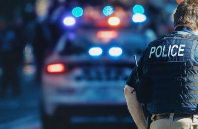 Policeman in front of a car