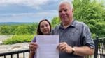 Ed Parks and Annmarie Palumbo-Parks hold a Project Hazelnut letter outside their Pennsylvania home.
