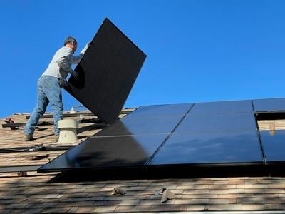TCS - man installing solar panels