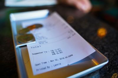 FILE - check, bill, tip, credit card, restaurant