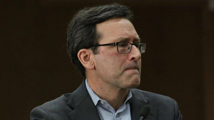 Close-up of Washington Gov. Bob Ferguson listening during a press conference.