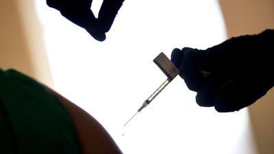 FILE — COVID-19 vaccine syringe