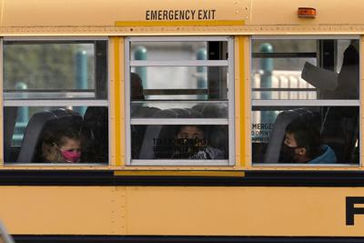 FILE - Illinois school bus, masks, students, 2020