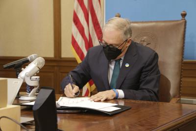 FILE - Inslee signing law
