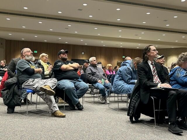 A group of Illinois residents attend the DuPage County Board meeting Monday, Jan. 24, 2023.