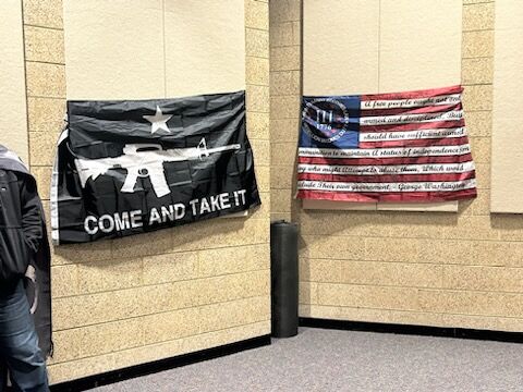 Flags put on display by Illinois residents attending the DuPage County Board meeting Tuesday, Jan. 24, 2023.