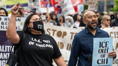 Protesters hold signs and chant during ICE protest in Chicago