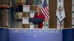 Pennsylvania Treasurer Stacy Garrity speaks at a podium with U.S. flags inside a warehouse.