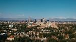 Denver skyline with Rocky Mountains in the background.