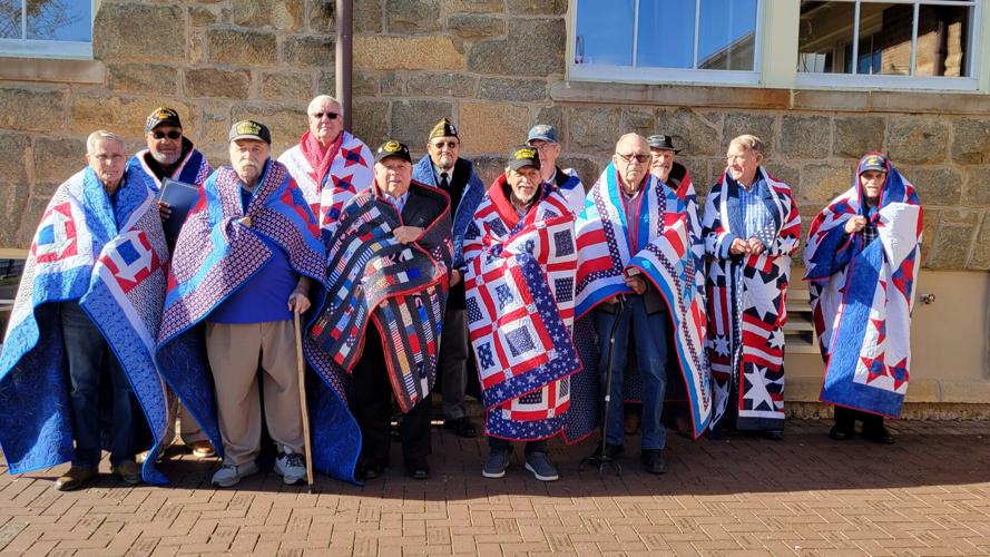 Veterans with their Quilts of Valor