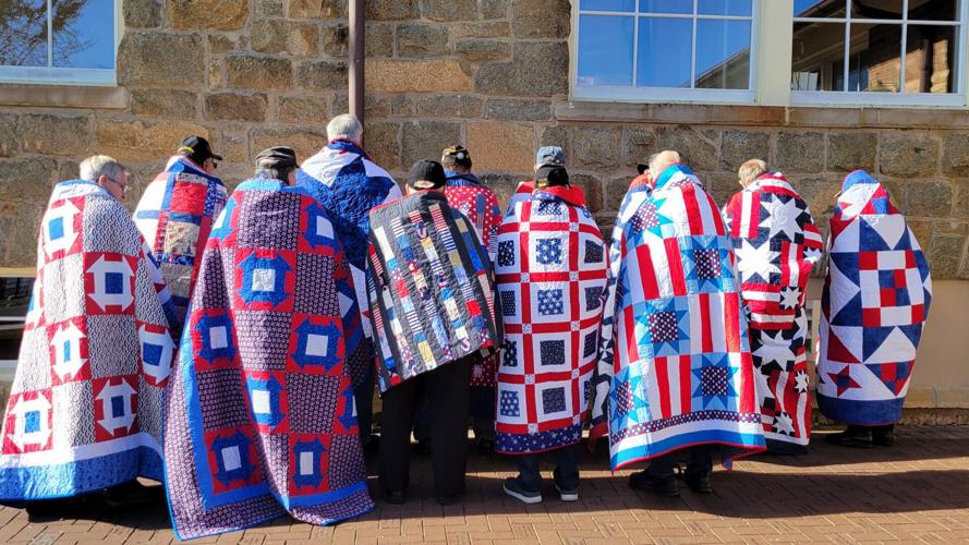 Veterans displaying their Quilts of Valor