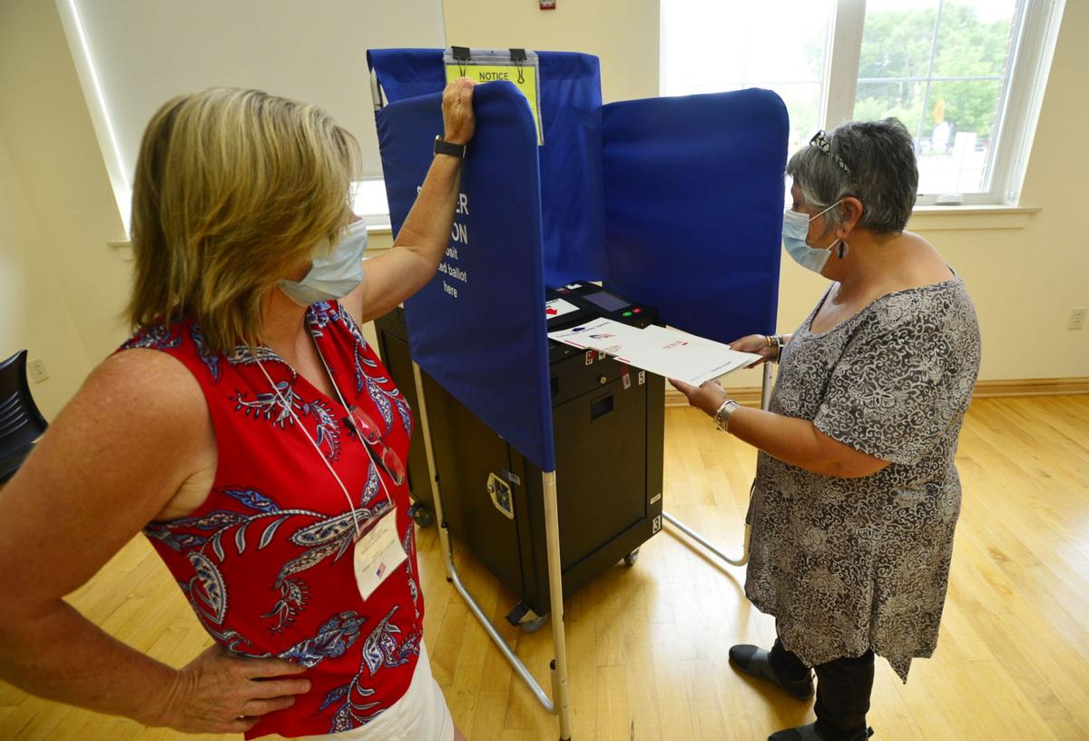 New precautions greet in person voters many absentee ballots issued