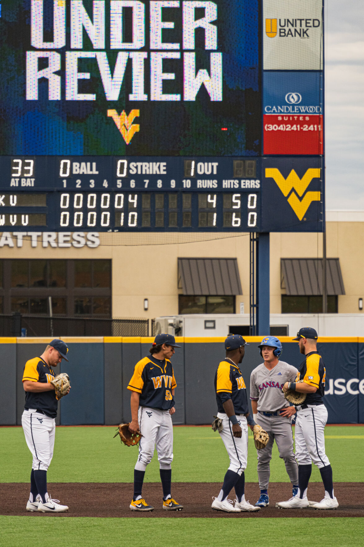 West Virginia's players wait while a play is being reviewed against Kansas on March 27, 2021, Morgantown, W.Va.