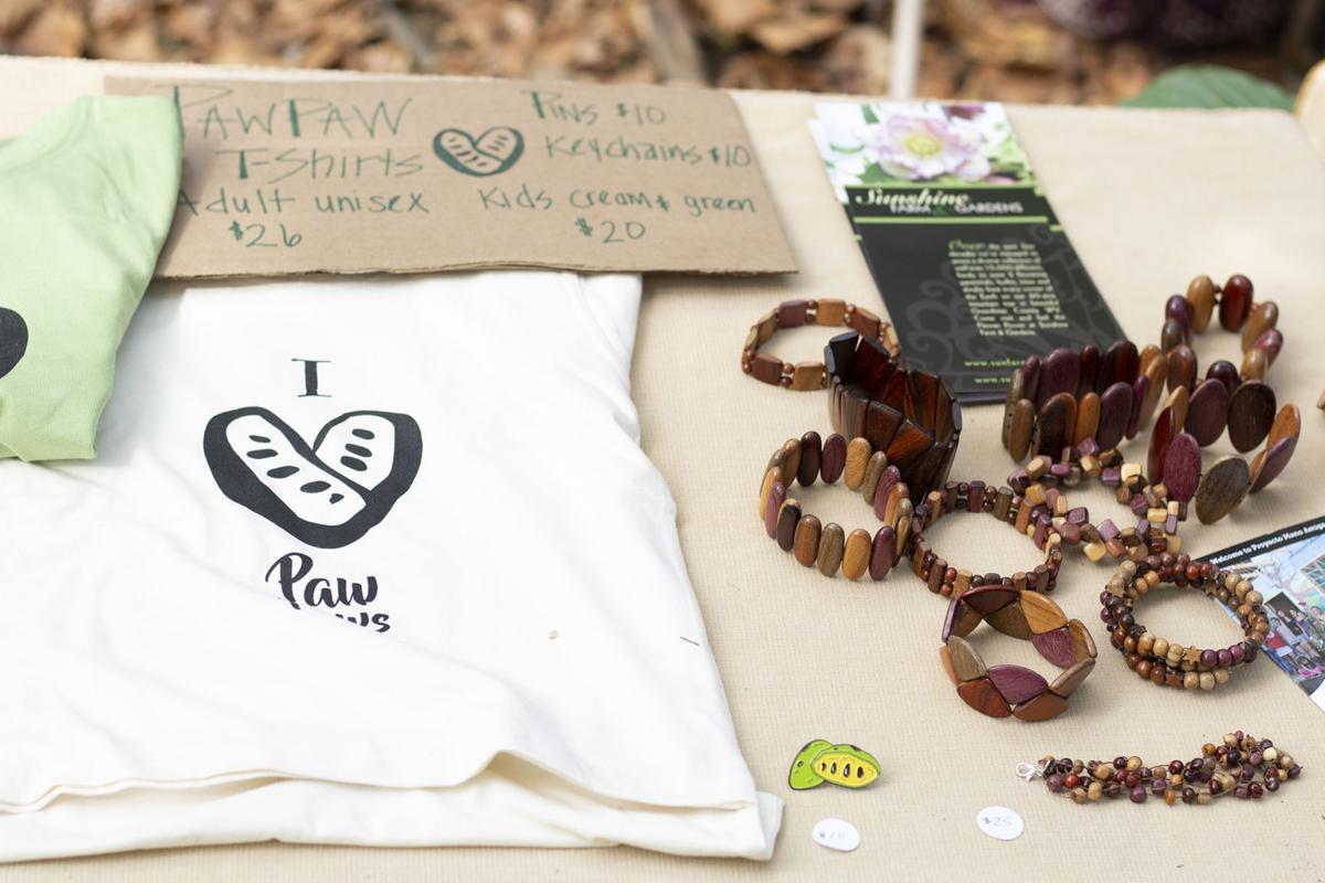 An assortment of accessories that represent the Paw Paw festival. Includes bracelets, pins, and shirts.