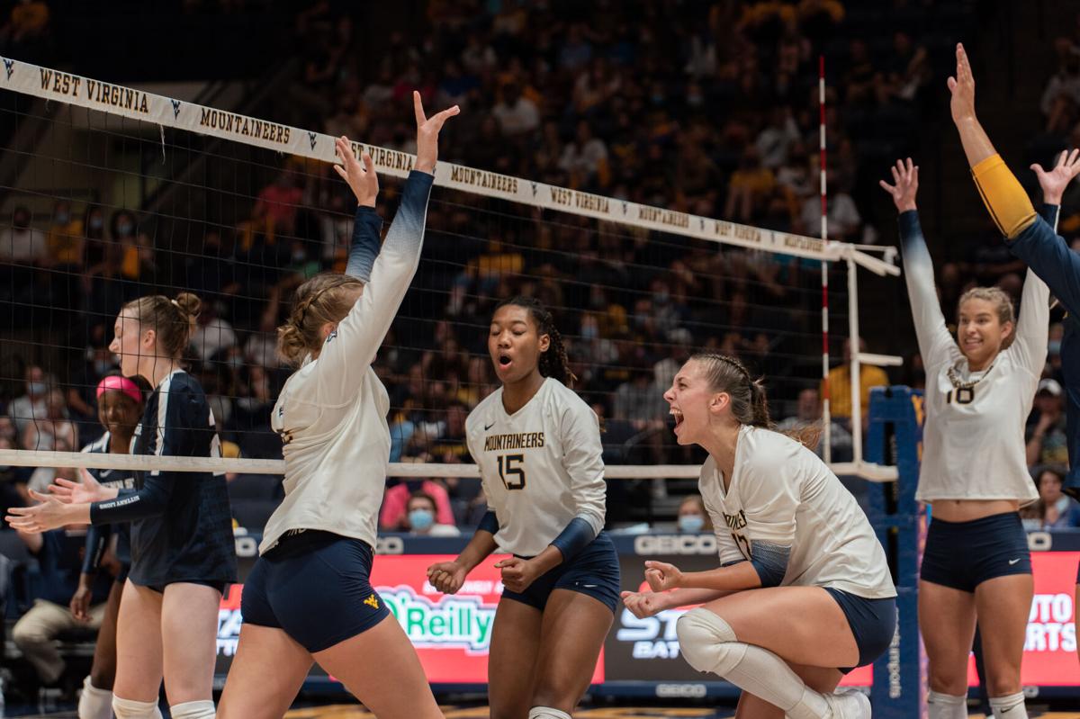 The WVU volleyball team celebrates a point against Penn State on Sept. 17, 2021.