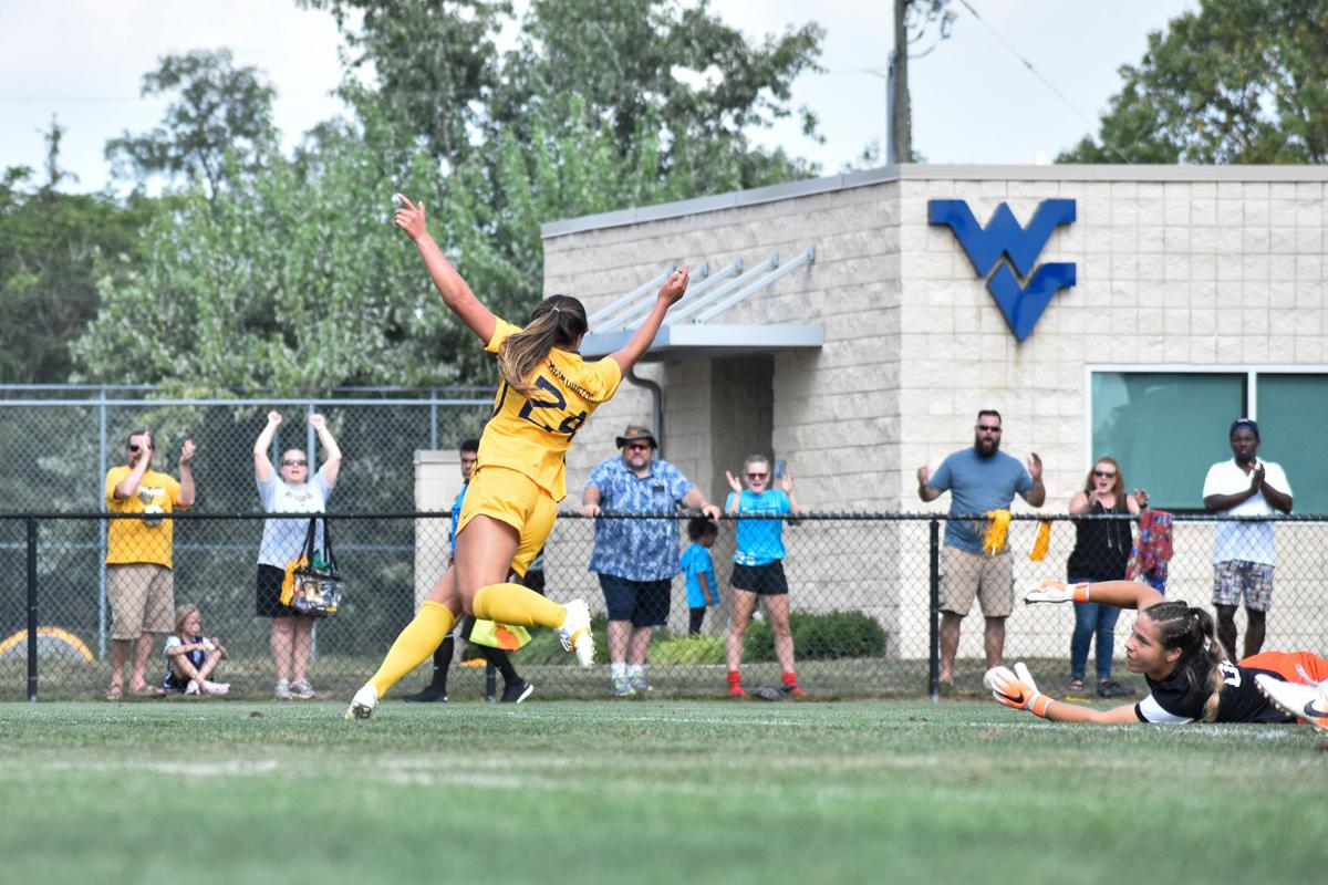 West Virginia's Alina Stahl (left) scores her second goal of the game against Bowling Green State University on Sep. 22. 