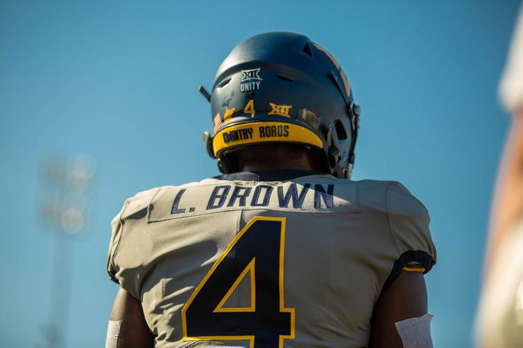 West Virginia running back Leddie Brown stands while doing pregame warm-ups against Long Island at Milan Puskar Stadium in Morgantown, W.Va., on Sept. 11, 2021. 