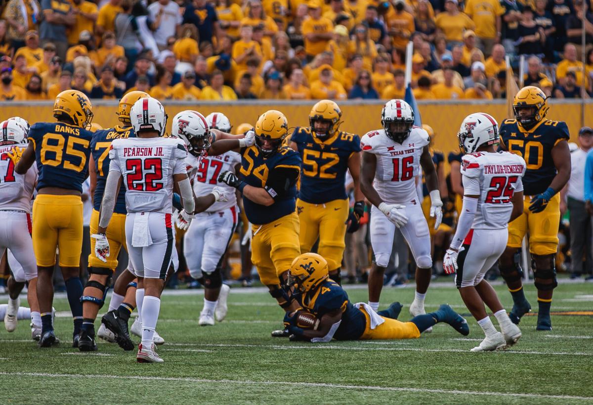 West Virginia running back Leddie Brown lays on the ground after a play against Texas Tech at Milan Puskar Stadium in Morgantown, W.Va., on Oct. 2, 2021. 