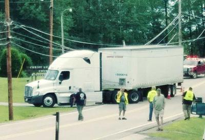 Tractor-trailer gets caught on lines