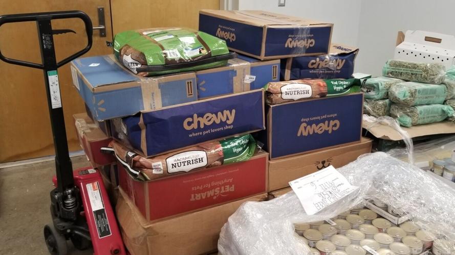 A stack of donated pet food in boxes
