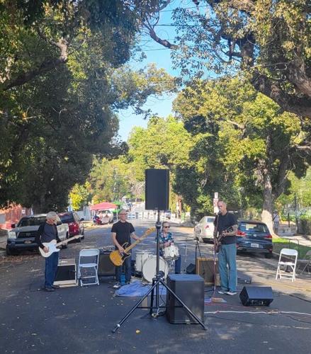 Band plays in middle of street under trees on Morton Avenue in Echo Park
