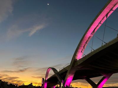 Sunrise over the purple arches of the Sixth Street Bridge