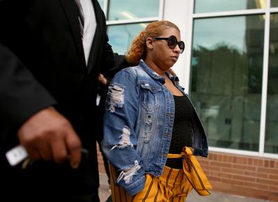 Deja Nicole Taylor, the mother of the 6-year-old shooter at Richneck Elementary School in Newport News, is escorted out by her legal team following her arraignment at the Newport News Circuit Court on Friday, April 14, 2023, morning.
