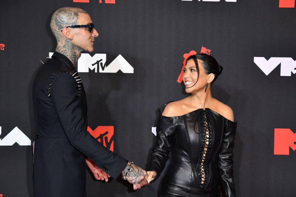 Travis Barker, left, and Kourtney Kardashian arrive for the 2021 MTV Video Music Awards at Barclays Center in Brooklyn, New York, on Sept. 12, 2021.