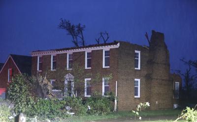 A two story brick home is left with no roof on Haversham Close in Virginia Beach, Virginia after a late afternoon storm move through on April 30, 2023.